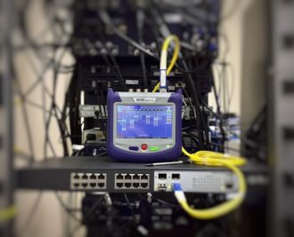 Modern optical fibre internet modem delivering high speed wireless internet to a home office in Canada.